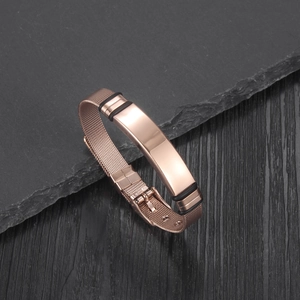 Macro view of rose gold Milanese mesh bracelet with a smooth curved plate and rubber rings