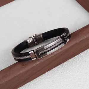 Detailed macro of black silicone strap with braided stainless steel inlay and folding clasp