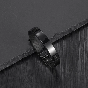 Close-up of black mesh stainless steel bracelet with a polished engravable metal plate
