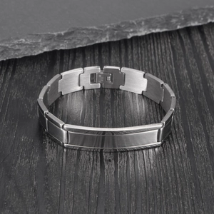 Bracelet pour homme en acier inoxydable brossé avec plaque incurvée sur fond de pierre