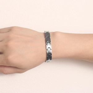 Minimalist silver stainless steel bullet chain bracelet worn on a wrist for modern look
