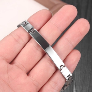 Detailed view of silver stainless steel curb chain bracelet with a blank ID name plate