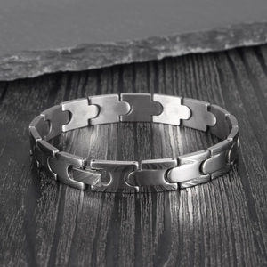 Macro view of interlocking bullet-shaped stainless steel links with brushed metal texture