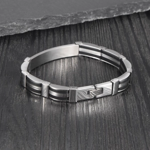 Close-up of black silicone and stainless steel links on a men's industrial bracelet