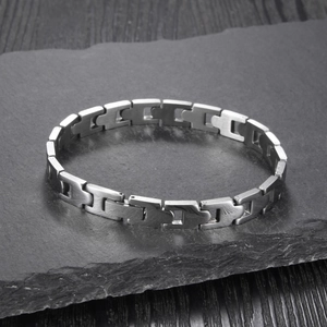 Macro detail of brushed stainless steel chain links on a dark slate background