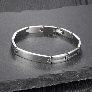 Vintage stainless steel twig shape bracelet with matte finish on slate stone surface