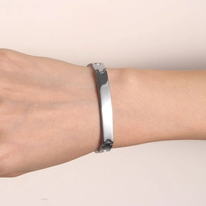 Minimalist silver-tone stainless steel curved bar bracelet with polished mirror finish
