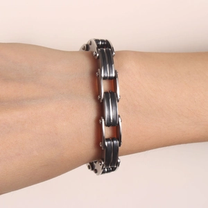 Punk style stainless steel and black silicone bracelet for men and women shown on wrist