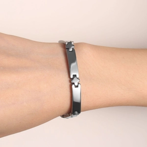 Polished stainless steel curved plate bracelet with cross charms on female wrist