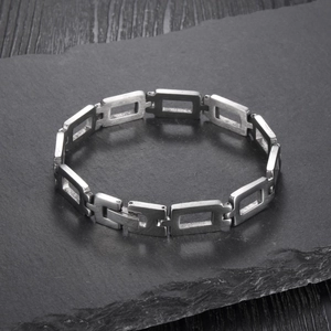 Close-up of hollow rectangular links on a minimalist silver stainless steel bracelet