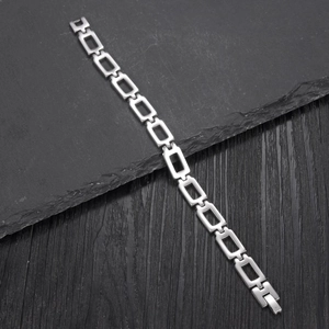 Minimalist silver hollow rectangle link stainless steel bracelet on stone background