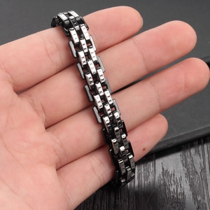 Men's titanium steel bracelet with black and silver X-patterned links on wrist