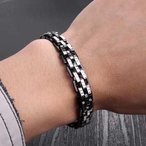 Men's titanium steel two-tone chain bracelet featuring black and silver X-pattern links