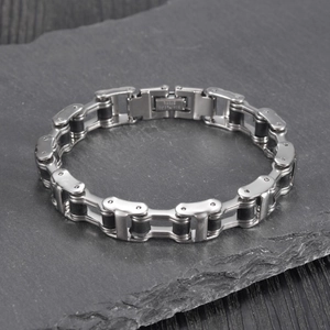 Close-up of stainless steel biker chain bracelet with engraved clasp and industrial link