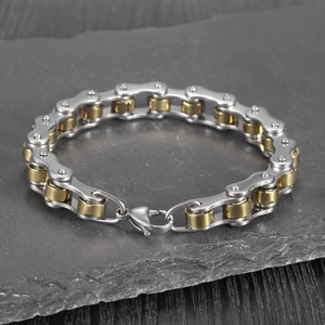 Detail of bicolour bike chain bracelet in gold and silver stainless steel with lobster clasp