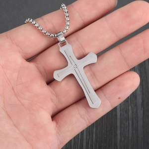 Detail of silver stainless steel cross pendant with diamond center on bead chain