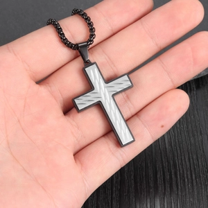 Close-up of men's cross necklace with laser-engraved wave textures and black bead chain