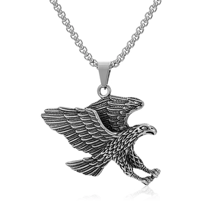 Detail of vintage eagle pendant with textured feathers and polished silver finish
