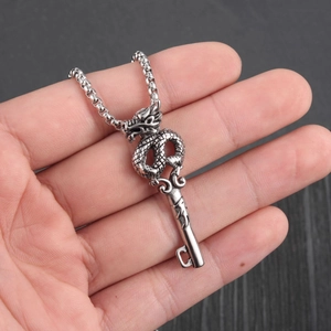 Silver dragon key pendant necklace with dragon sculpture detail on a square bead chain