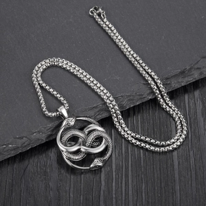 Detailed close-up of intertwined twin snake pendant in vintage silver steel finish