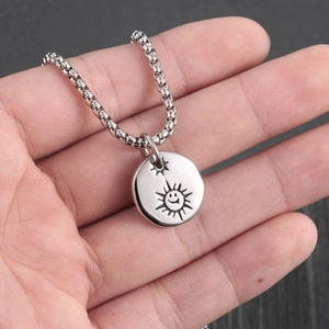 Detail of silver sun smiley face and star engraving on punk titanium steel pendant necklace