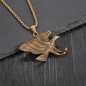 Detailed view of vintage gold eagle pendant with intricate feather texture and box chain