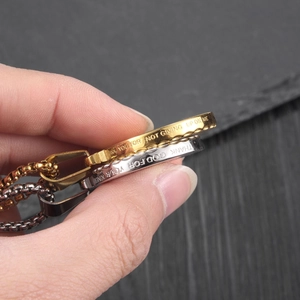 Stainless steel embossed medallion necklace with side engraving in gold and silver finish