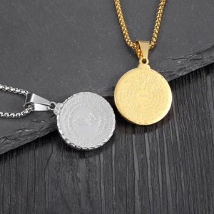 Detailed close-up of gold and silver religious round pendants with engraved prayers
