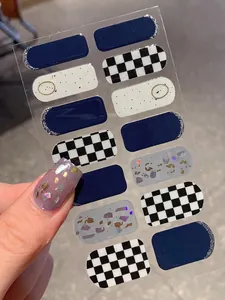 Detail showing 14pcs dark blue and checkered nail wraps with mixed foil pattern