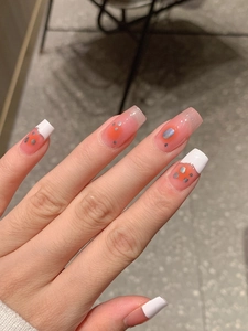 Detail of pink gradient nail stickers with white French tips and silver foil accents