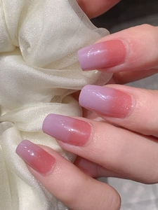 Macro shot of long square nails with light purple ombré gradient and subtle shimmer