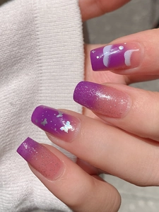 Detail of purple gradient nail stickers with silver glitter and butterfly art decorations