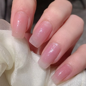 Classic pink gradient French style press-on nails with glitter on silk background