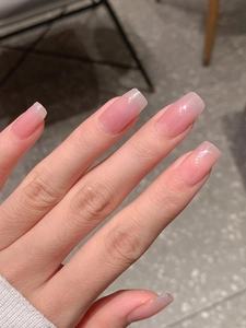 Detailed view of glossy light purple gradient press-on nails with fine glitter finish