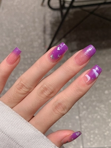 Macro detail of purple gradient press-on nails with silver glitter and butterfly sequins
