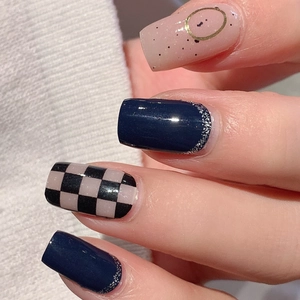 Mixed press-on nail set with dark blue glitter, checkerboard pattern and gold accents