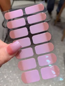 Macro shot of light purple gradient press-on nails with shiny finish on real hand