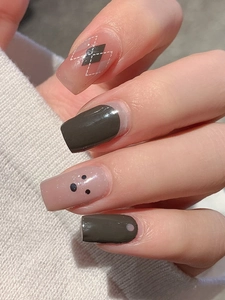 Detail of argyle pattern and brown square-oval nail stickers with knit sweater background