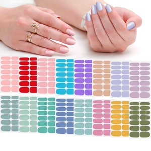 Detail showing various solid color nail polish stickers and applied look on fingernails