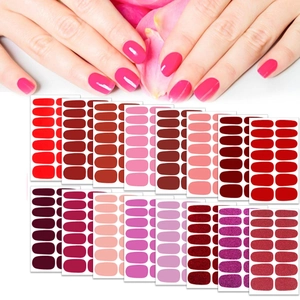 Detailed view of multi-color nail sticker set featuring solid shades and glitter finishes