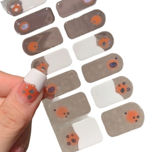 White French blush nail stickers with orange accents and silver glitter decorations