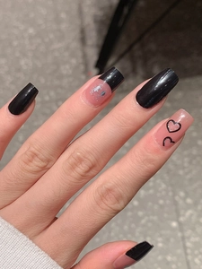 Long coffin press-on nails with black and nude pink design featuring silver glitter and hearts