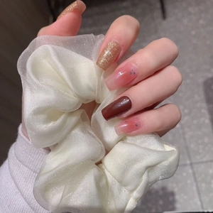 Valentine's Day nail stickers in wine red and gold with a white organza scrunchie