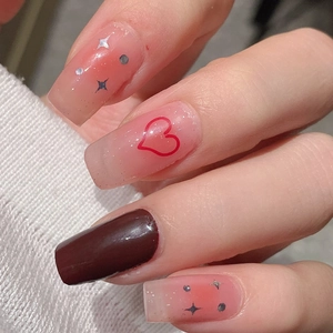 Long square press-on nails with pink gradient, brown tones, heart patterns and silver stars