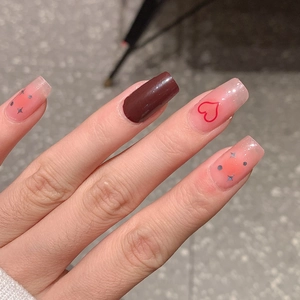 Pink gradient and dark brown press-on nails with red heart and silver star patterns