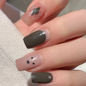 Deep gray and green square press-on nails with dark diamond pattern on knit background