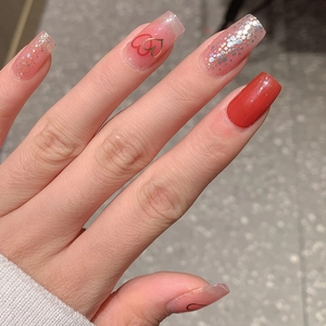 Faux ongles rose gelée et rouges avec motifs de cœurs, paillettes et forme carrée