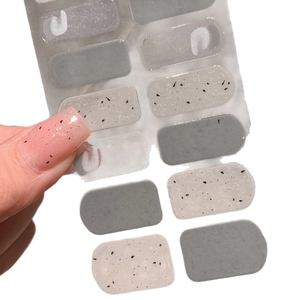 Gray and dalmatian pattern semi-cured gel nail stickers displayed on a clear backing