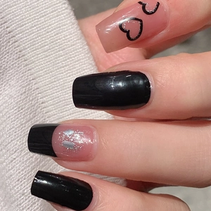 Glossy black and pink heart press-on nails in long square shape on soft knit background