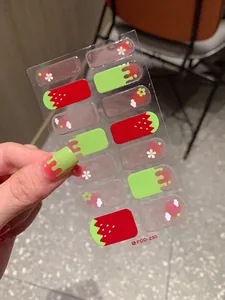 Detail of sweet strawberry nail stickers with floral patterns and jelly texture